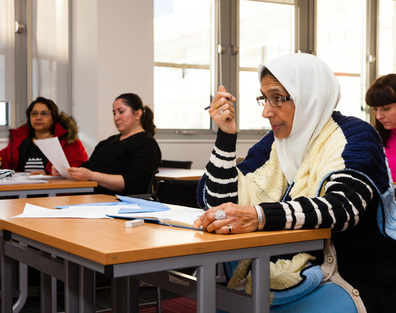 ESOL. female students listening to a lecture. ethnic mix