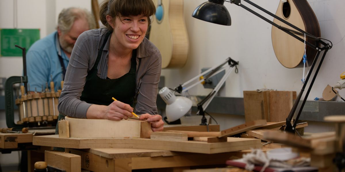 Musical Instrument Making Student At Workbench