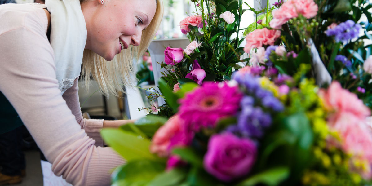 Floristry Student With Large Floral Arrangement