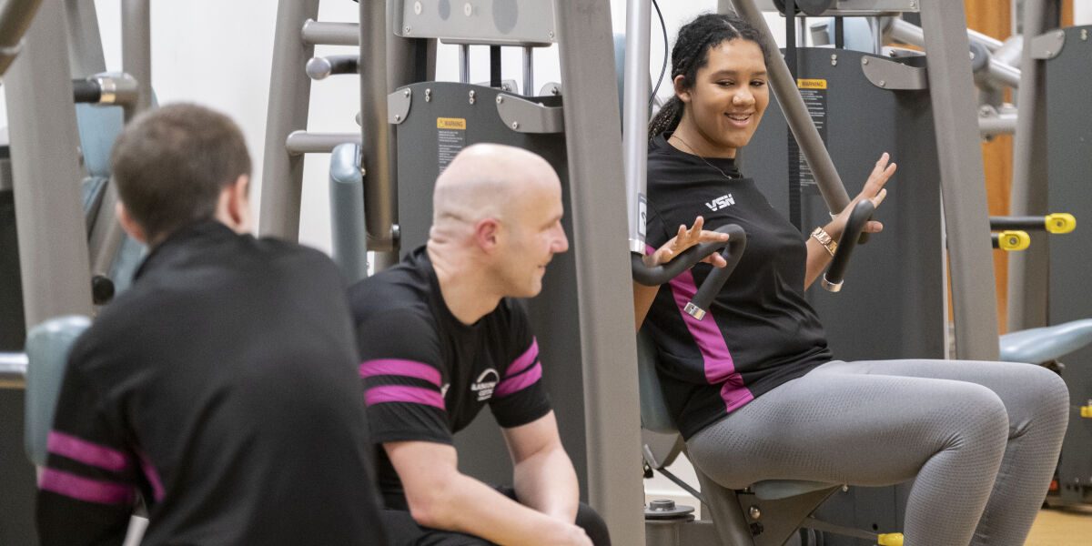 Fitness students using weights in the gym