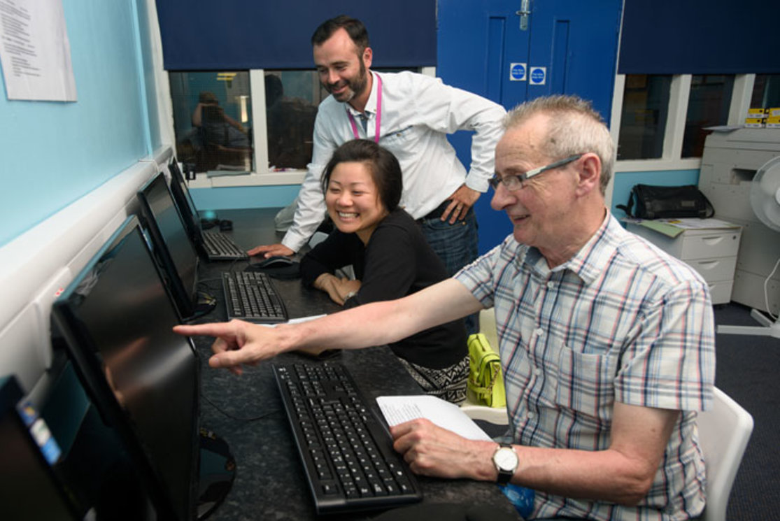 Adult community classes man pointing to pc gallery
