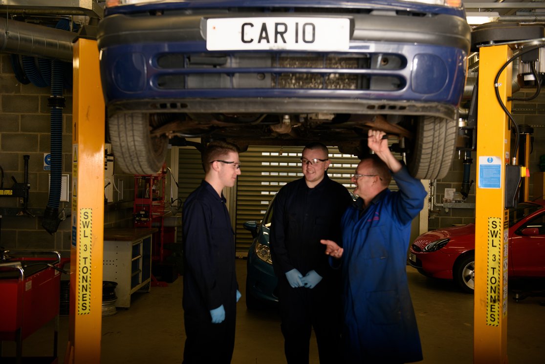 Automotive inspecting underneath car with lecturer %286%29 gallery