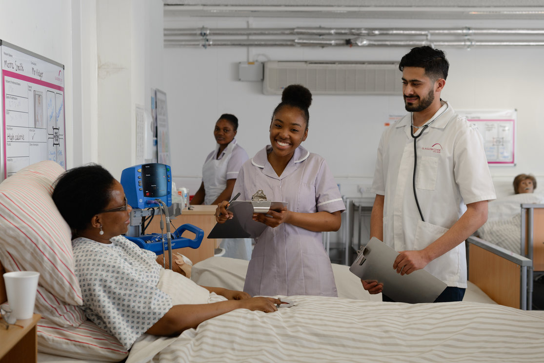 Esol transitions to health care   students at bed with patient   image 4 gallery