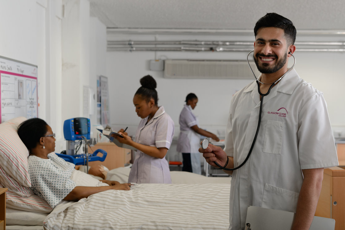Esol transitions to health care   students at bed with patient   male at front   image 3 gallery