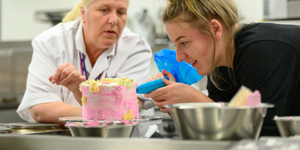 Cake decorating lecturer with student (2)