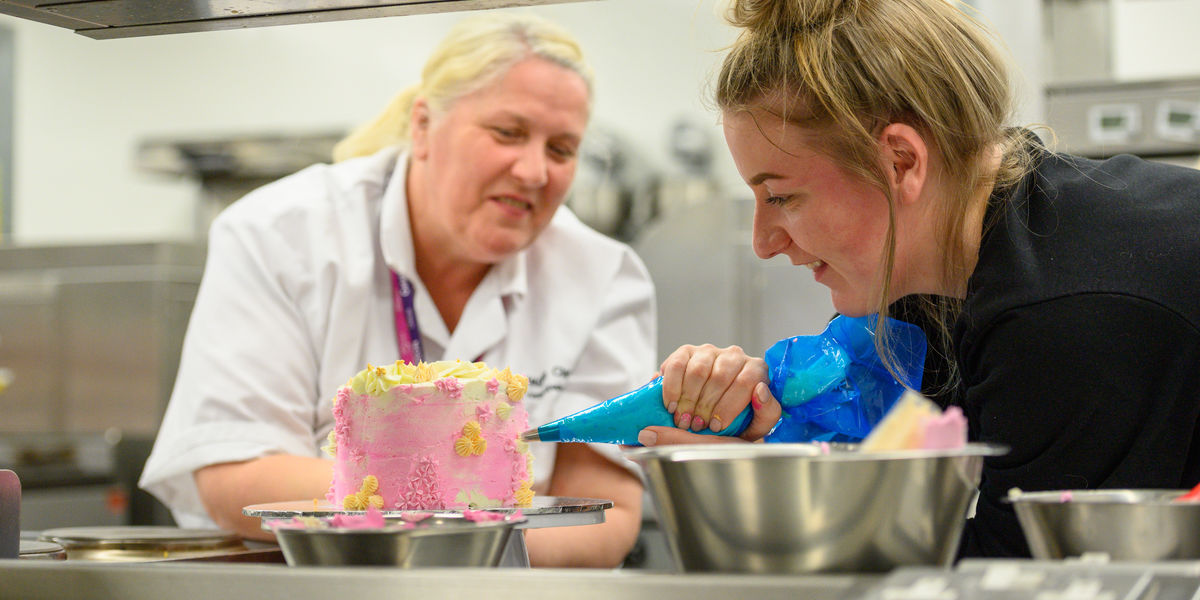 Cake decorating lecturer with student (5)