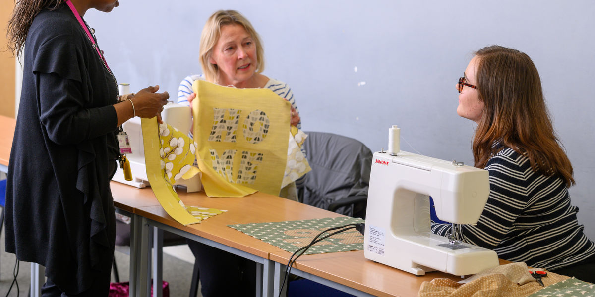 Ladies with lecturer at sewing machines (6)