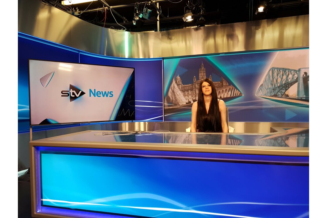 Michelle sitting at the stv newsdesk gallery