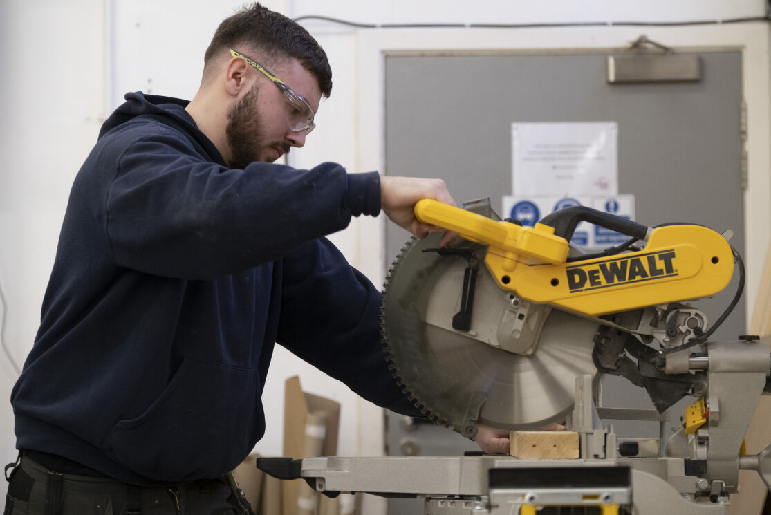 Male construction student working with electric saw gallery