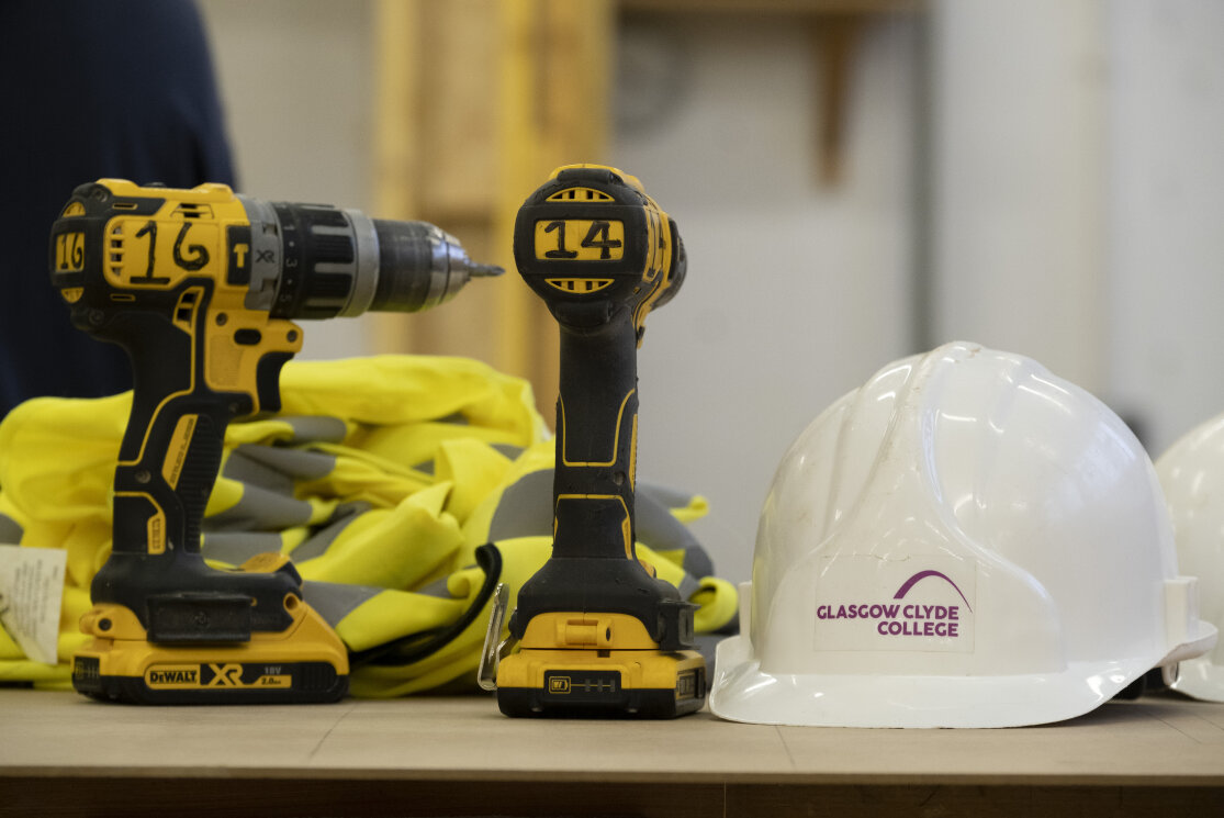 Drills and hard hats on a workbench gallery