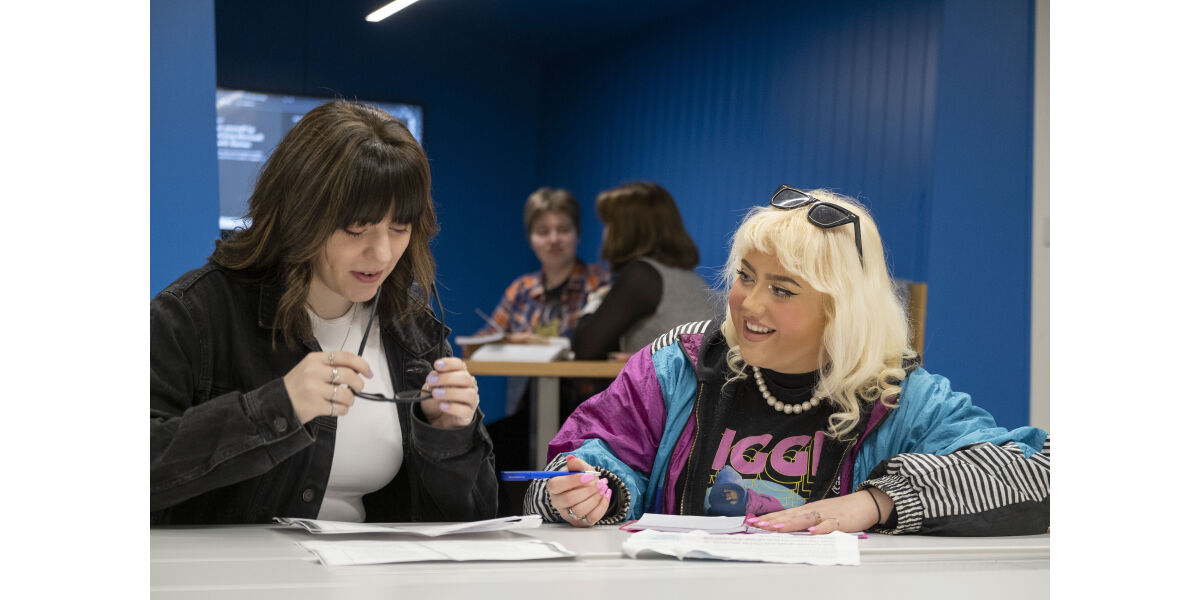 Two students sitting studying
