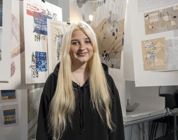 Female Art student smiling among her art