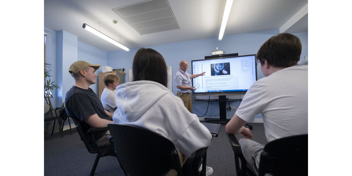 Male lecturer teaching HND Counselling to class at Anniesland Campus