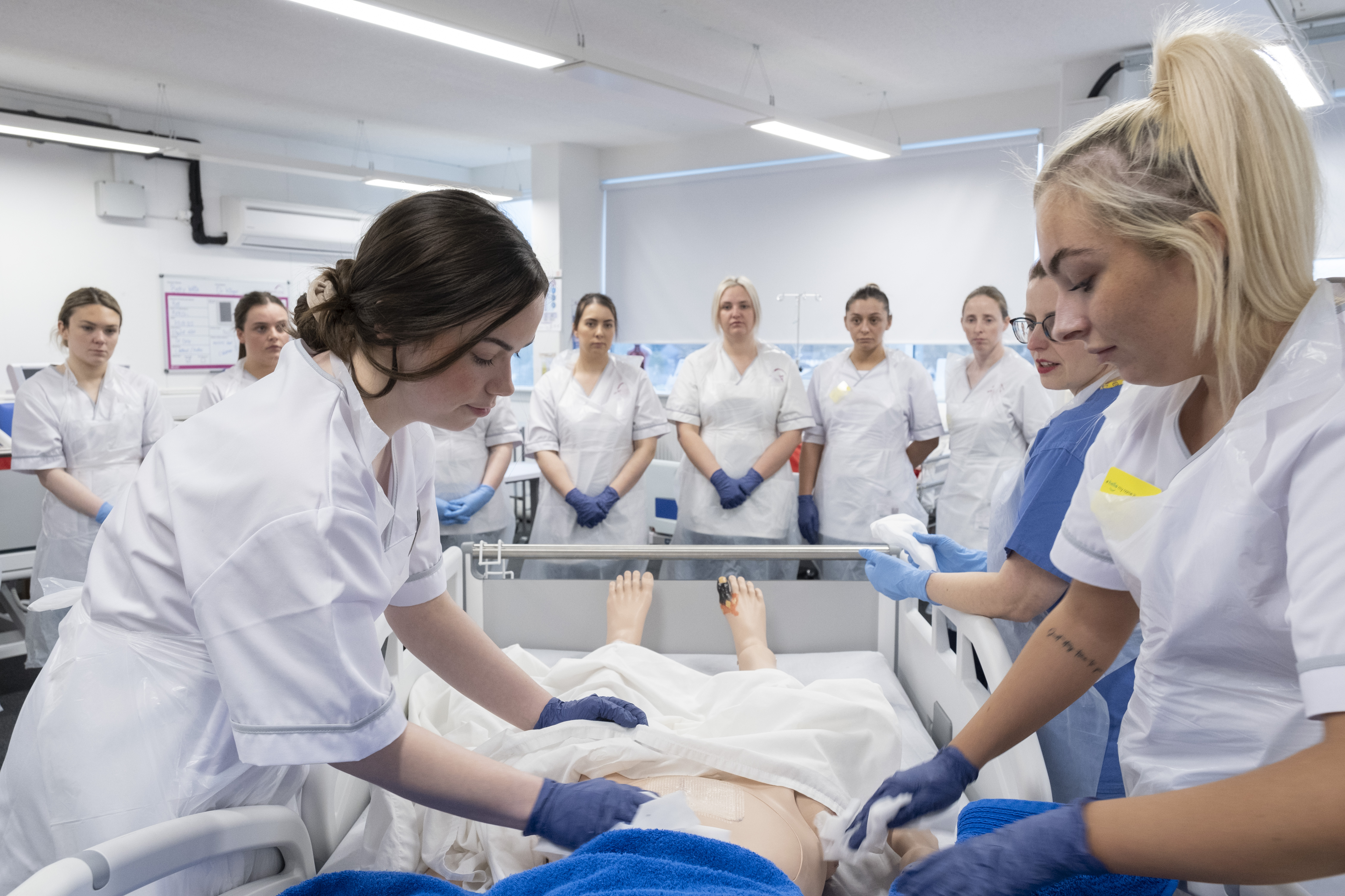 Health Care students in class working on a resuscitation dummy 