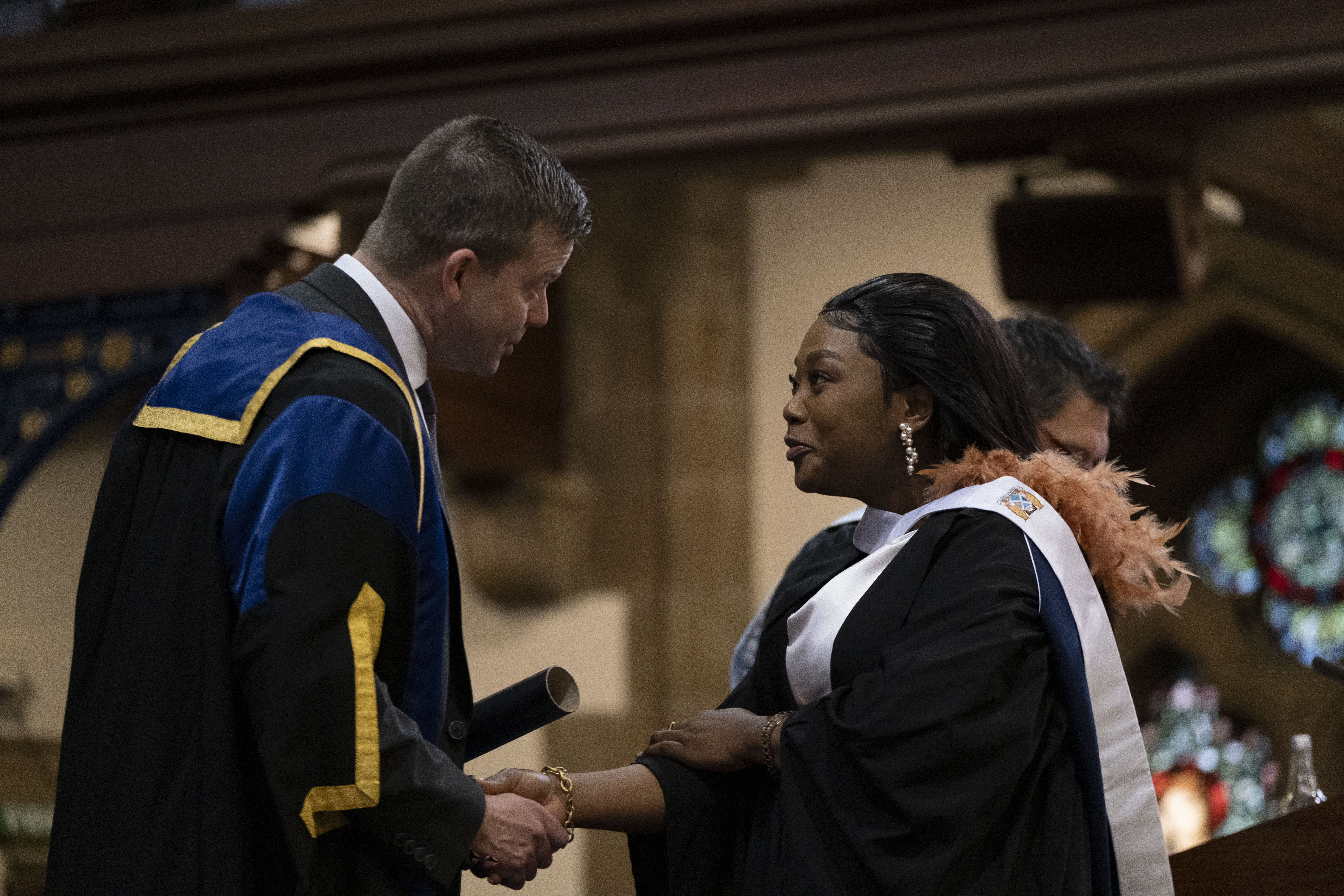 Principal presenting female graduate