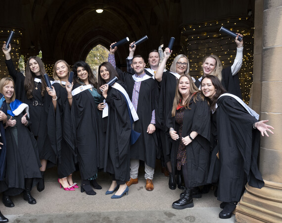 Class of graduates with scroll