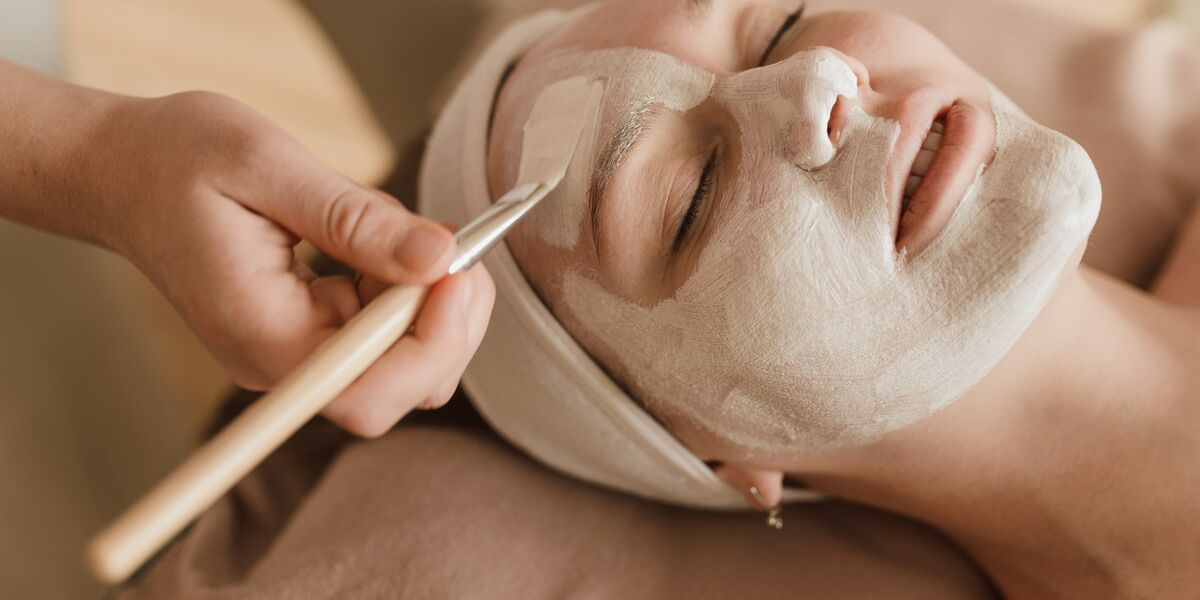 A Beauty Therapy student administering a facial.