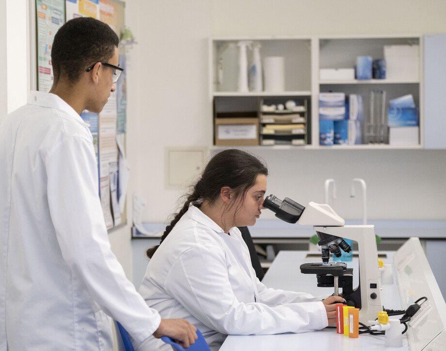 Two students using a microscope