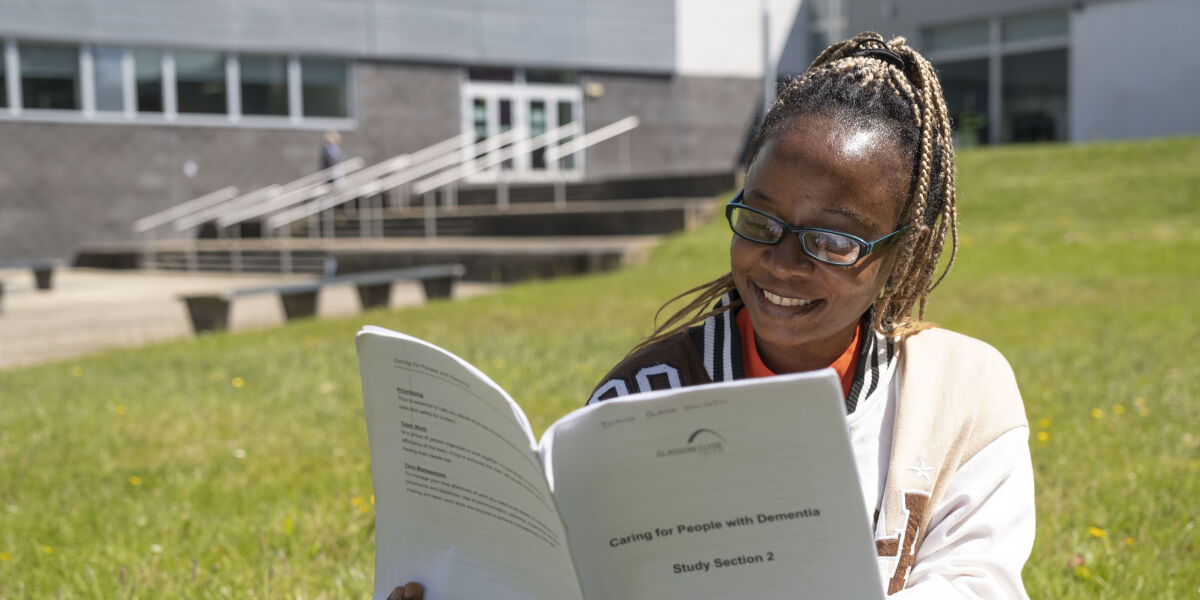 Social Care student reading class notes