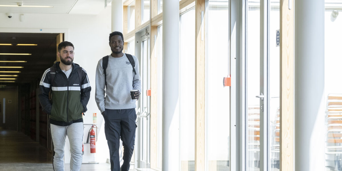 2 male students walking in corridor at Anniesland Campus Glasgow Clyde College
