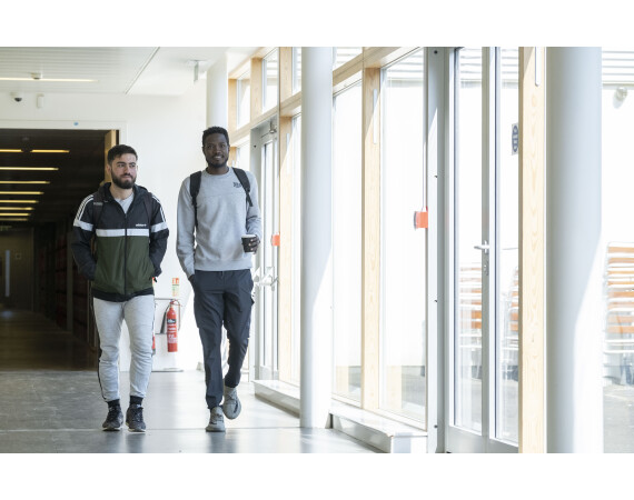 2 male students walking in corridor at Anniesland Campus Glasgow Clyde College