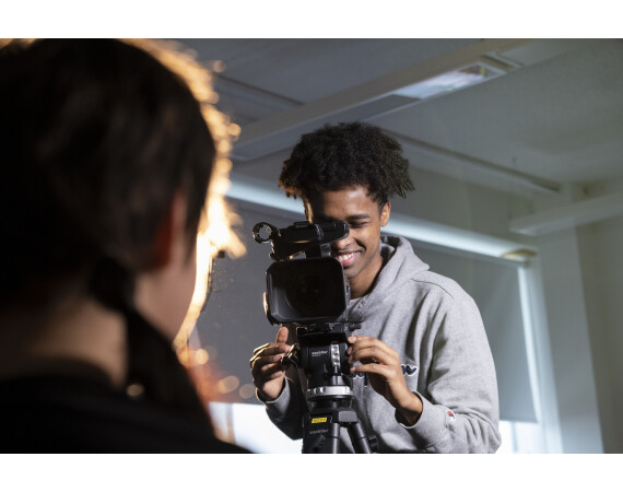 Male TV student filming interview