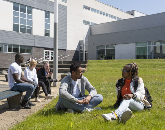 A group of students sitting outside chatting