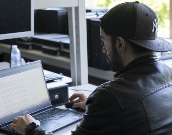 Male IT student with a laptop