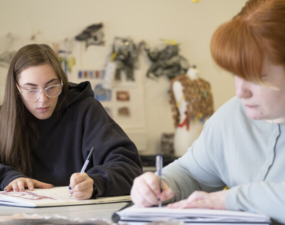 Two Female Art Students Writing