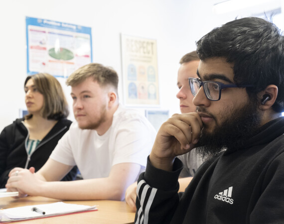 A group of students listening