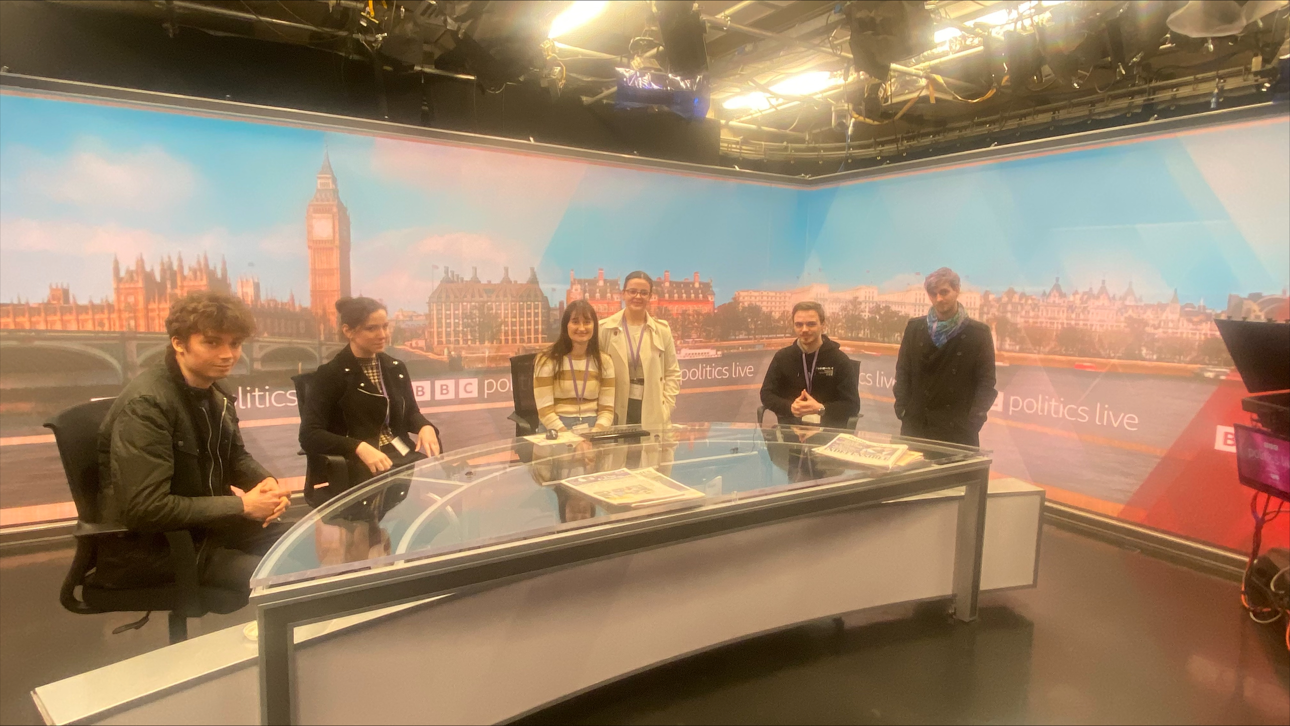 Journalism students sitting at the bbc newsdesk