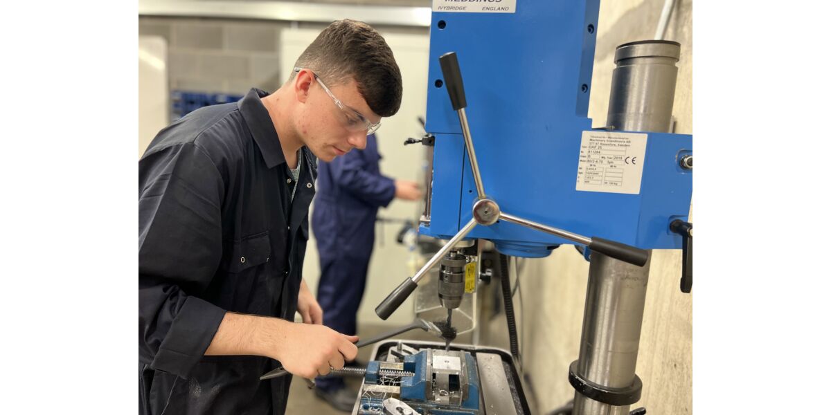 Male mechanical engineering student with machinery