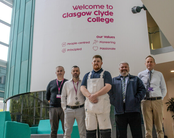 Image shows Persimmon Homes apprentice Ricky Booth with Ian McPherson from Persimmon Homes and Glasgow Clyde College Painting and Decorating teaching staff.