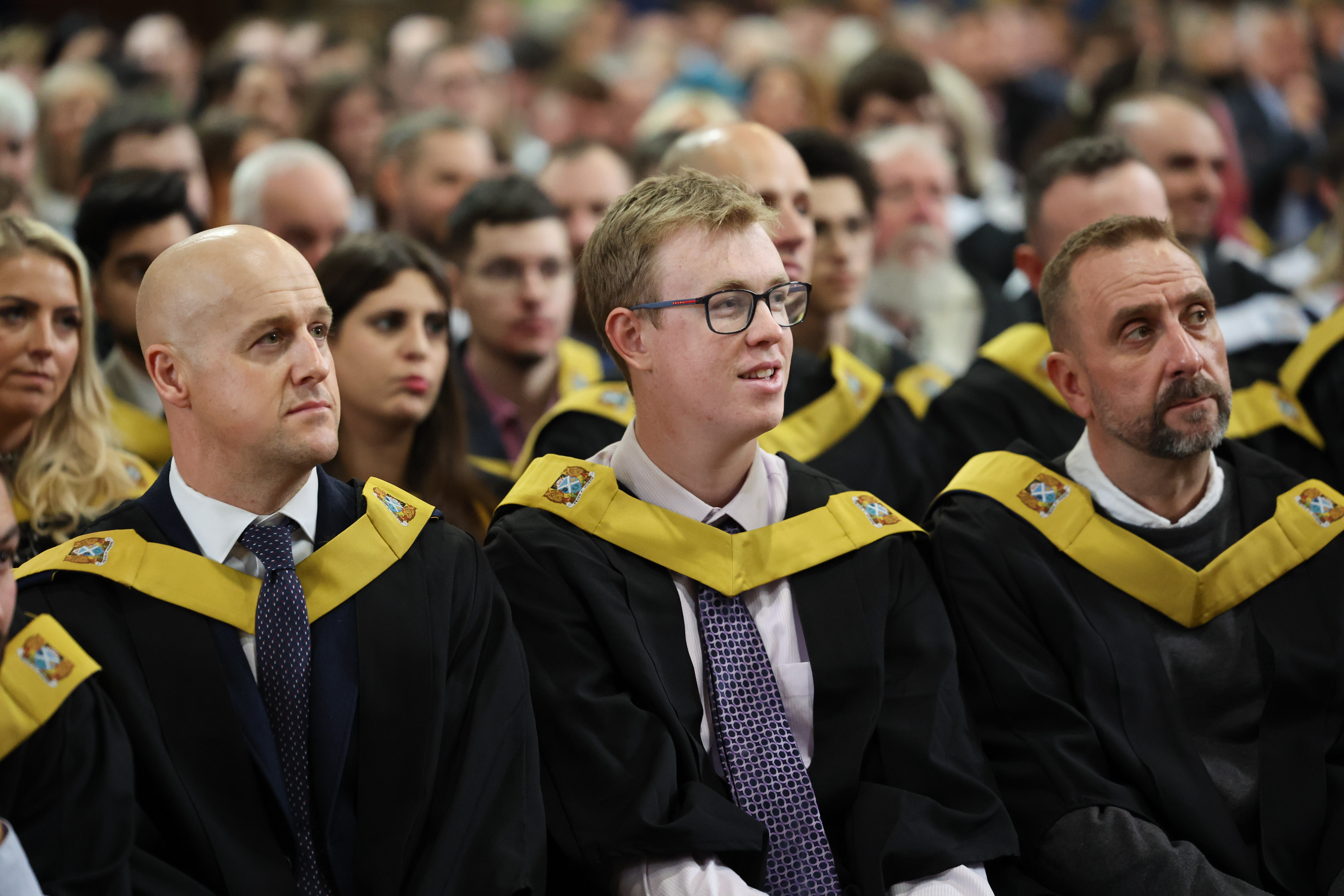 Graduation image showing smiling male students