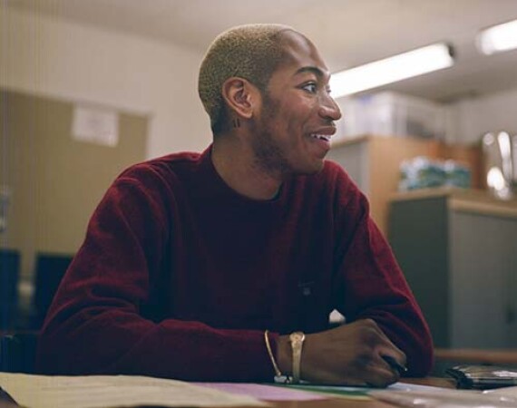 Male student in classroom looking to one side 