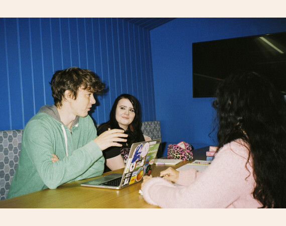 Mixed group of students having discussion.