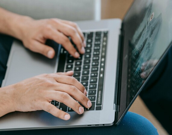 A male student using a laptop.