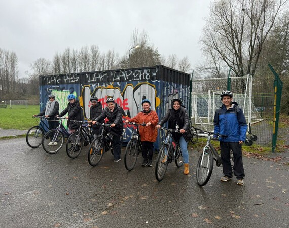 Image shows a group of students on bikes with the cycling campus officer.