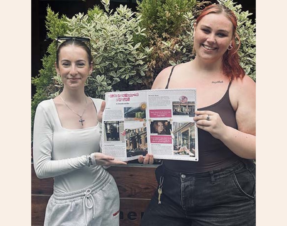 Journalism students holding copy of Aff Campus