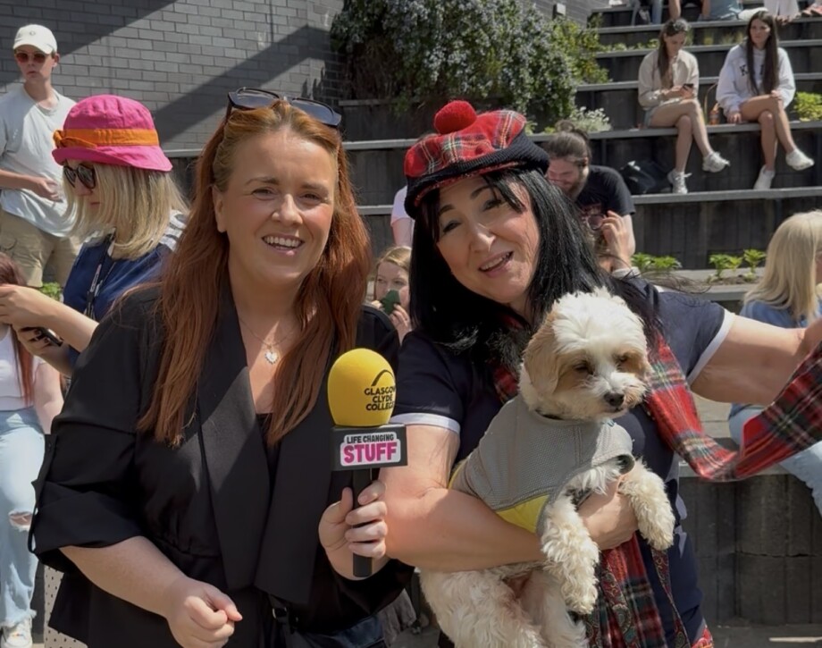 2 staff members and a little dog enjoying the summer festival at Langside campus
