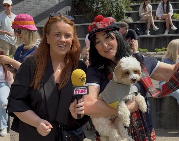 2 staff members and a little dog enjoying the summer festival at Langside campus