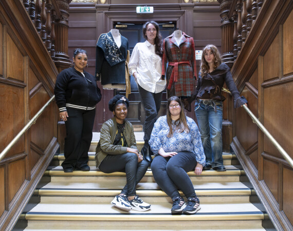 Image shows all the winning students at the main staircase of Trades House with winning garments